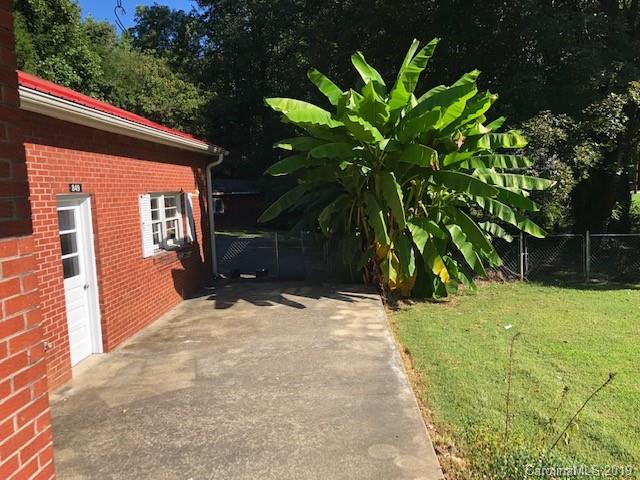 849 Fairview Road Marion, NC 28752 - Photo 12 of 15 a backyard of a house with large trees and plants
