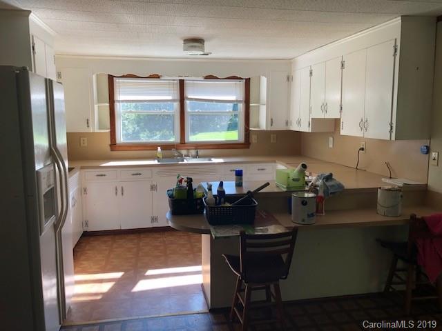849 Fairview Road Marion, NC 28752 - Photo 9 of 15 a kitchen with a sink cabinets and window