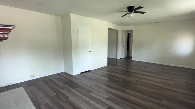 a view of room with wooden floor and ceiling fan