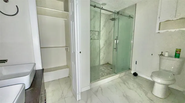 a bathroom with a toilet and a shower