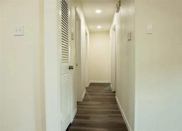 a view of a hallway with a door