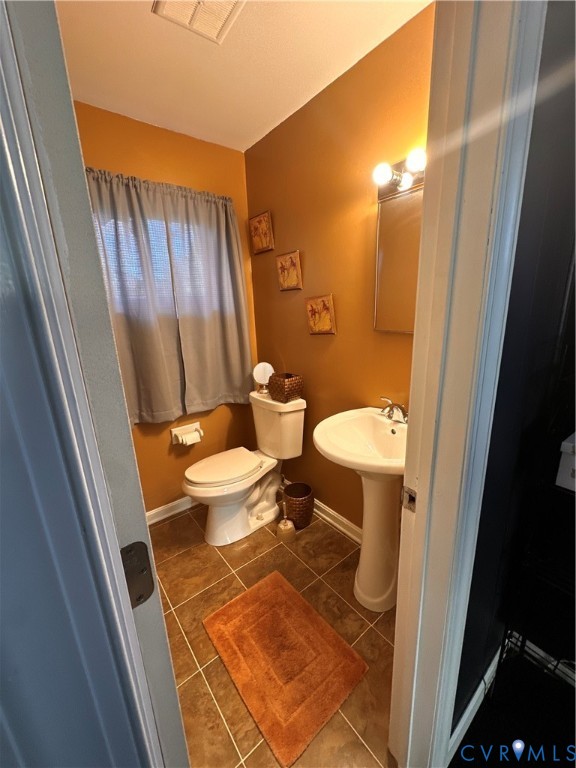 4018 Norborne Road Richmond, VA 23234 - Photo 12 of 15 Bathroom with dark tile patterned flooring and bas