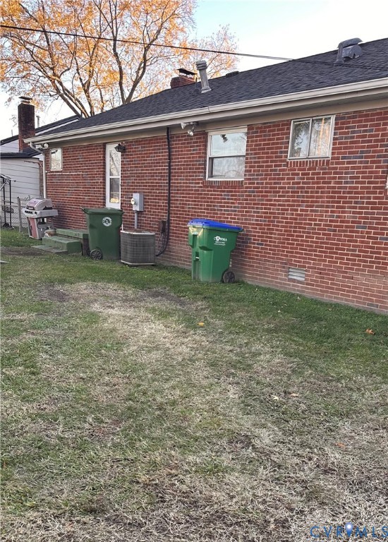 4018 Norborne Road Richmond, VA 23234 - Photo 14 of 15 View of side of property featuring a yard, brick s