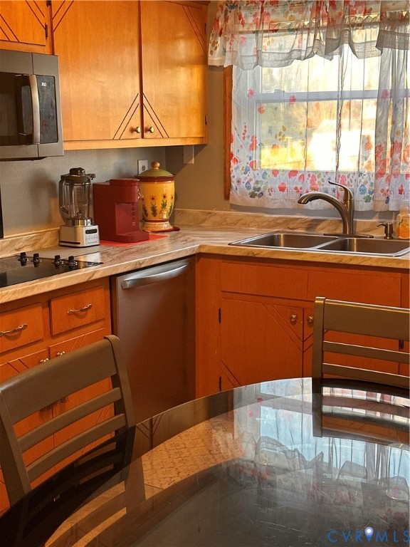 4018 Norborne Road Richmond, VA 23234 - Photo 9 of 15 Kitchen featuring light countertops, brown cabinet