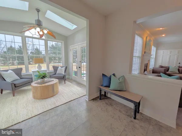 a view of a livingroom with furniture wooden floor and a chandelier