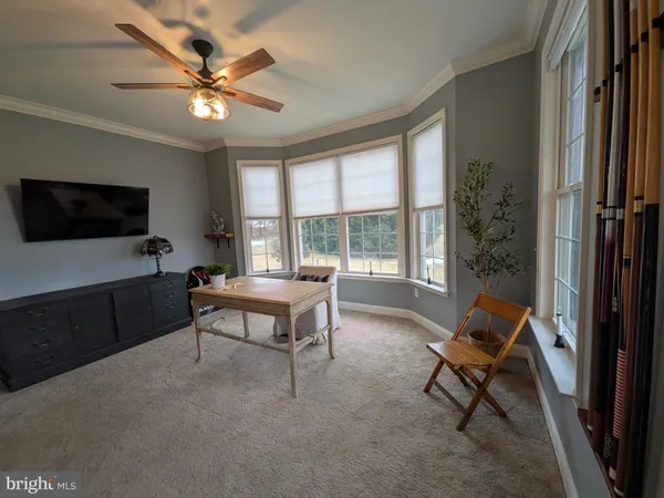 a view of a hallway with wooden floor and entryway