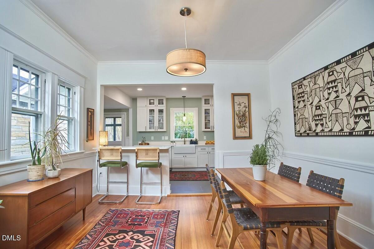 1313 Watts Street Durham, NC 27701 - Photo 13 of 44 a view of a dining room with furniture window and wooden floor