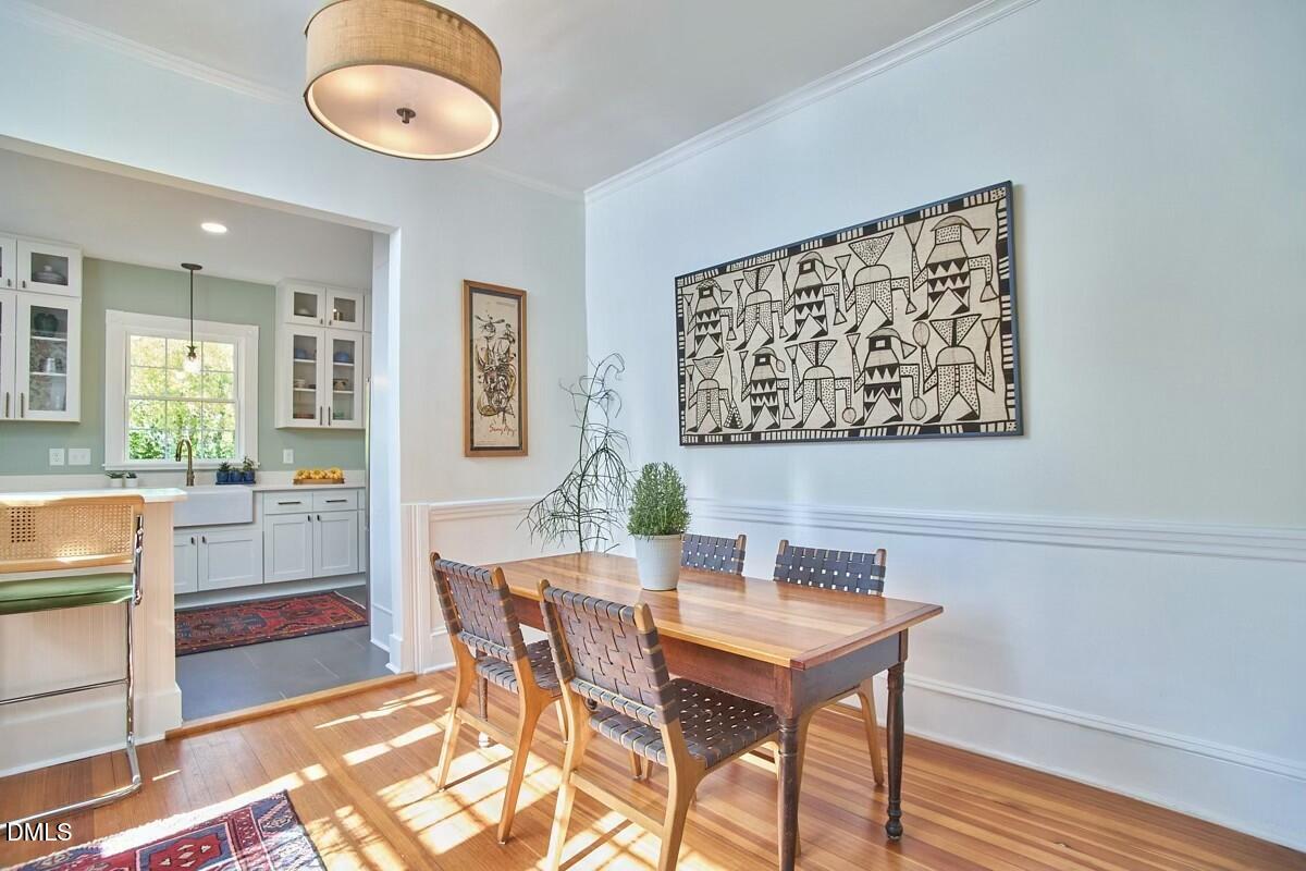 1313 Watts Street Durham, NC 27701 - Photo 14 of 44 a view of a dining room with furniture and wooden floor
