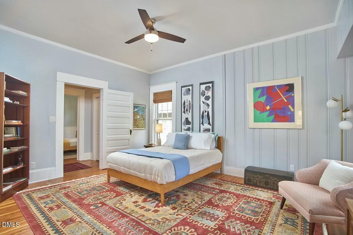 1313 Watts Street Durham, NC 27701 - Photo 30 of 44 a bedroom with a bed and wooden floor