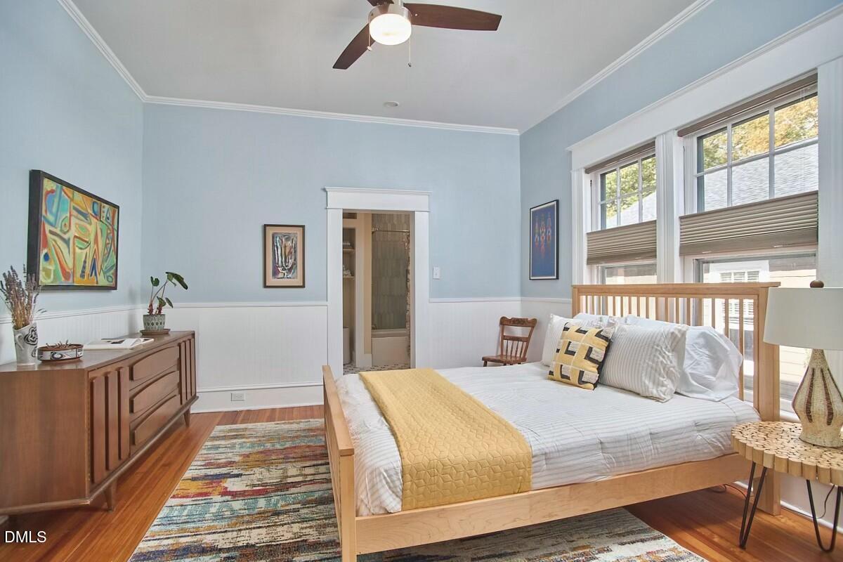 1313 Watts Street Durham, NC 27701 - Photo 34 of 44 a bedroom with a bed and wooden floor