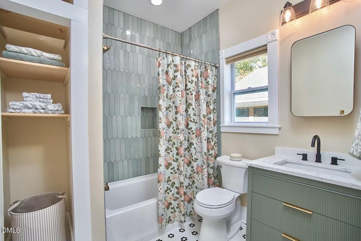 1313 Watts Street Durham, NC 27701 - Photo 36 of 44 a bathroom with a sink toilet and shower