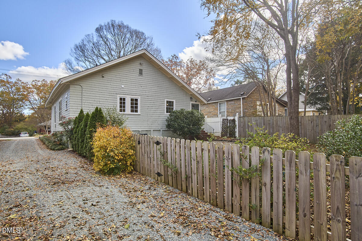 1313 Watts Street Durham, NC 27701 - Photo 40 of 44 a view of a house with wooden fence next to a yard
