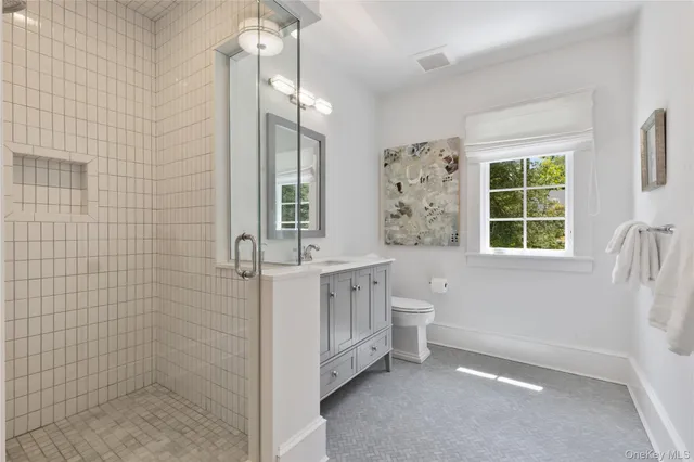 a bedroom with furniture and a large window