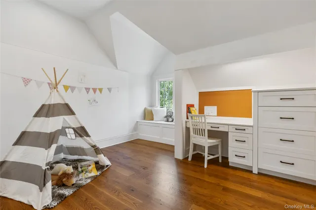 a bathroom with a granite countertop toilet sink and mirror