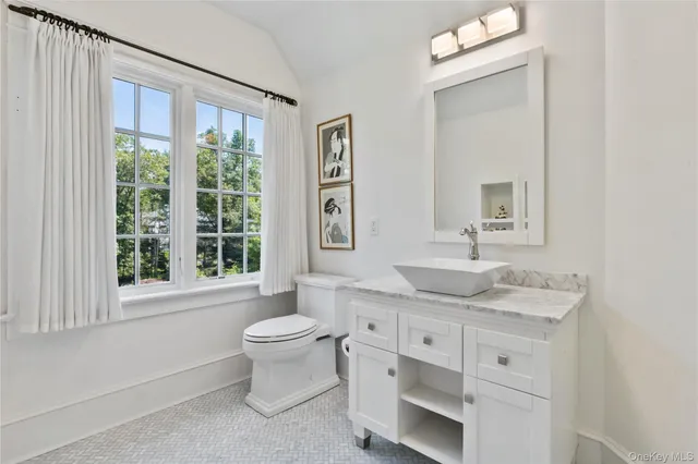 a bedroom with a large bed and wooden floor