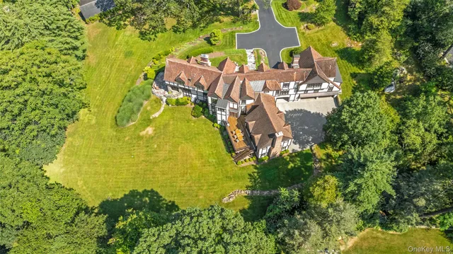 a view of a roof deck with table and chairs a barbeque with wooden floor and fence