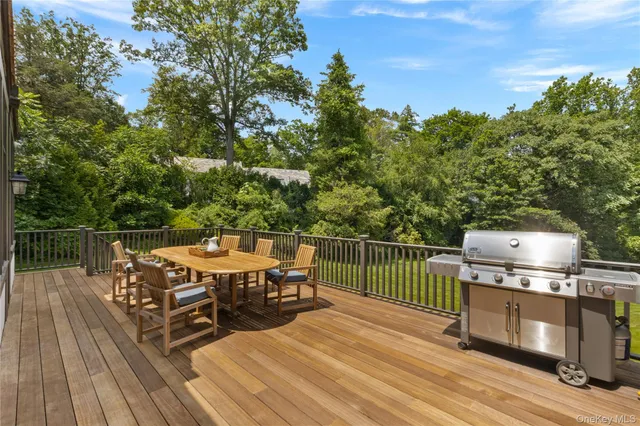 a view of a house with a big yard and large trees