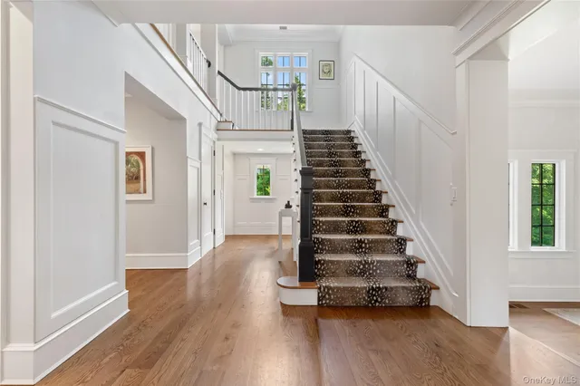 a large white kitchen with lots of counter space and stainless steel appliances