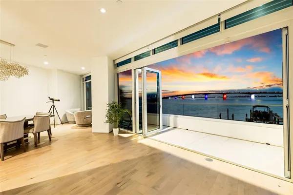 a large kitchen with kitchen island a large counter top space a sink a window and stainless steel appliances