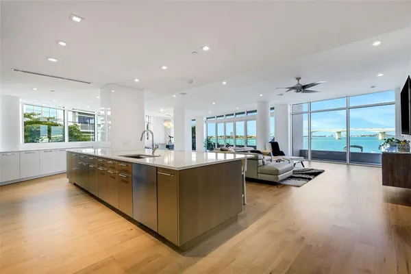 a kitchen with stainless steel appliances granite countertop a sink and a stove
