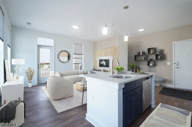 a view of kitchen with stainless steel appliances granite countertop a stove and a refrigerator