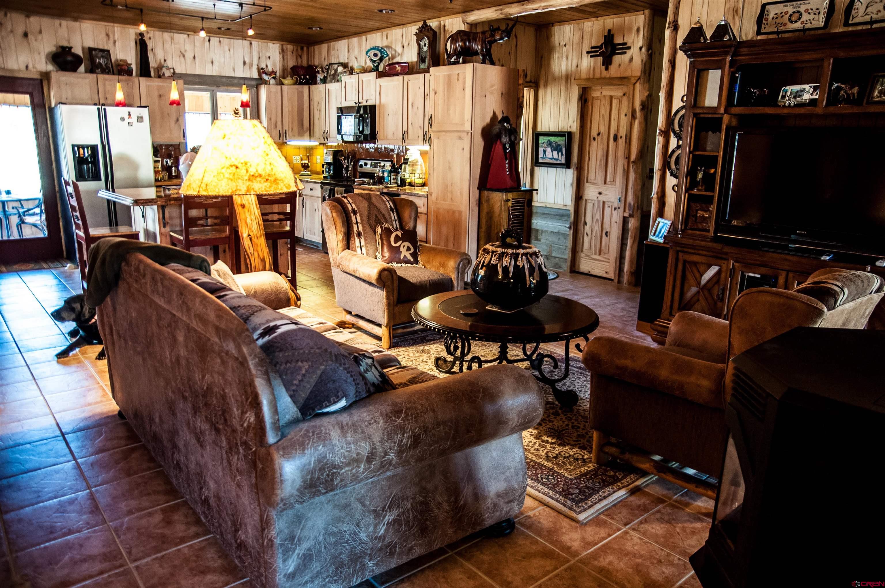 521 Dilley Ranch Road Canon City, CO 81212 - Photo 14 of 20 a living room with furniture and a flat screen tv