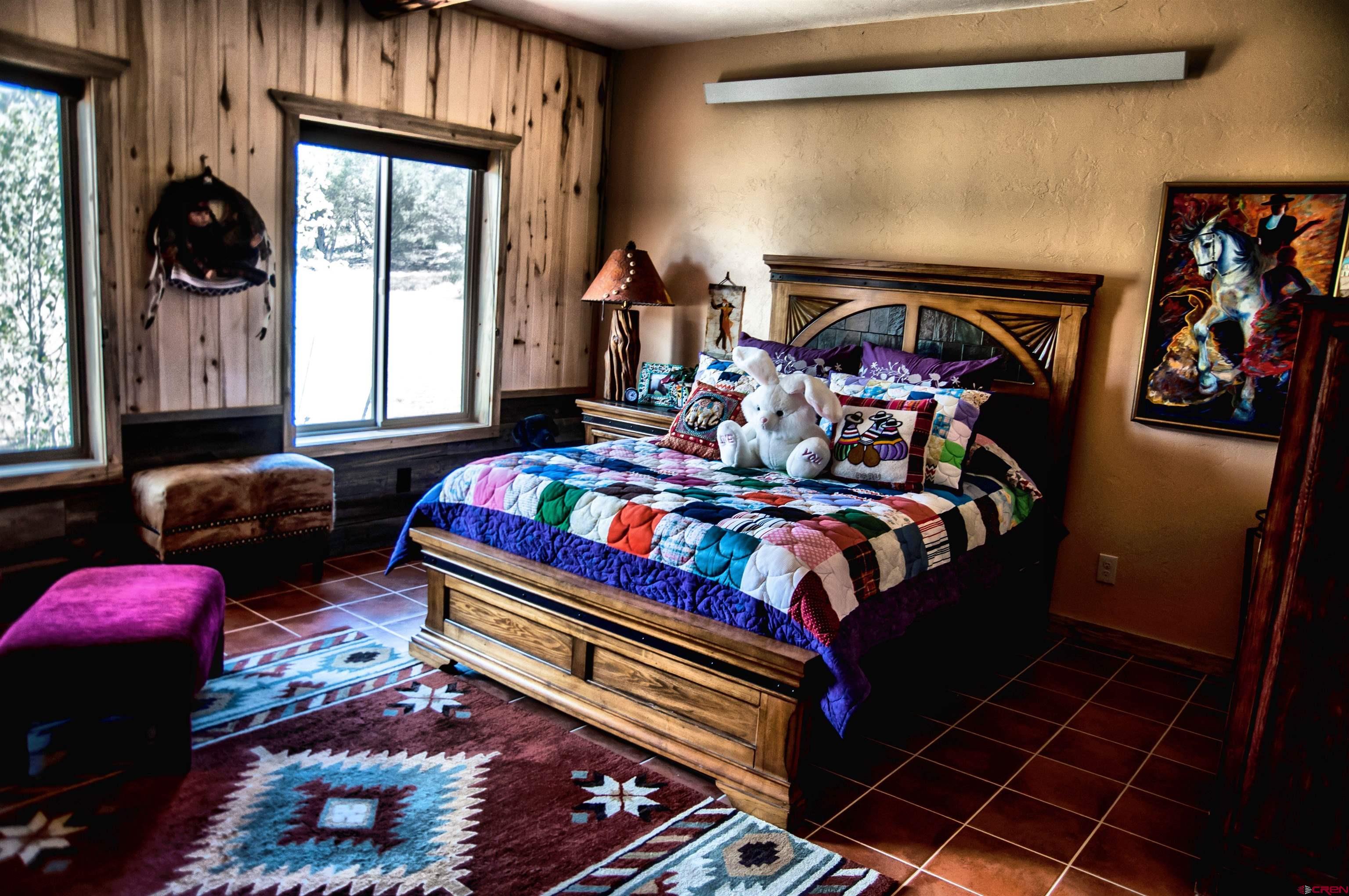 521 Dilley Ranch Road Canon City, CO 81212 - Photo 15 of 20 a bedroom with bed and a window