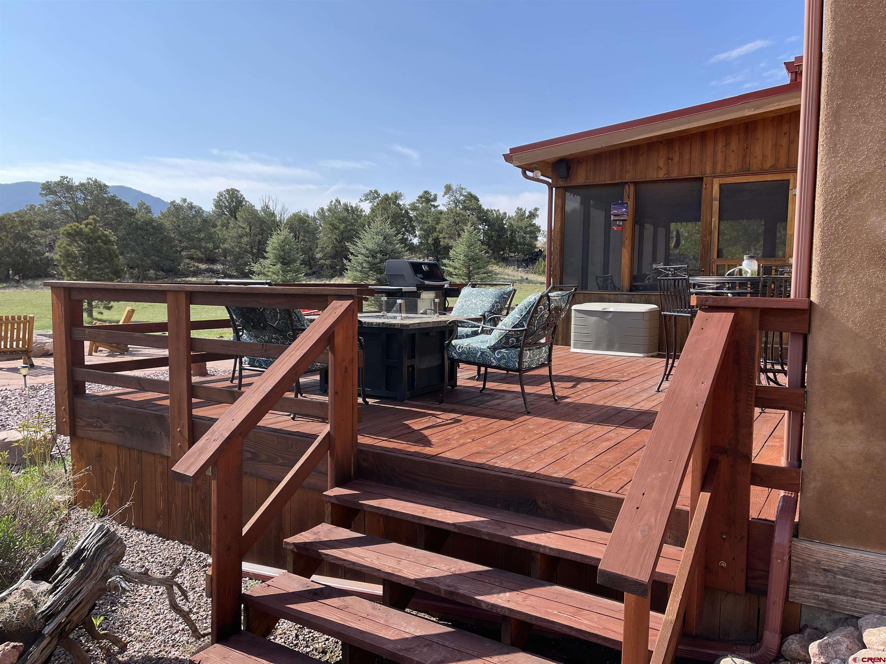521 Dilley Ranch Road Canon City, CO 81212 - Photo 8 of 20 a view of a patio with wooden floor and iron fence