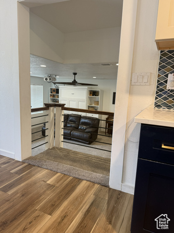 175 North 160 East Hurricane, UT 84737 - Photo 19 of 43 Bar featuring wood finished floors, light stone counters, backsplash, dark cabinetry, and a textured ceiling