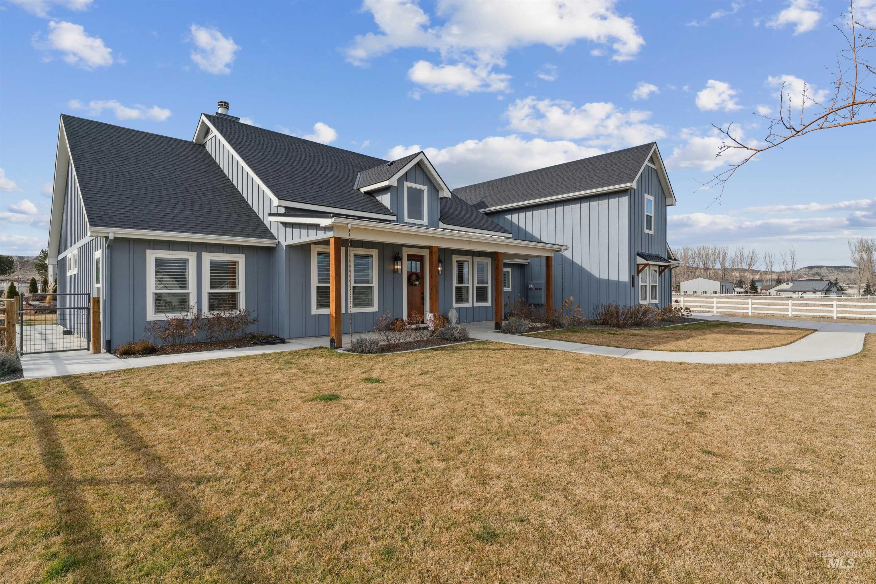 547 Bass Run Lane Marsing, ID 83639 - Photo 11 of 49 Modern farmhouse with a porch, roof with shingles, board and batten siding, and a gate