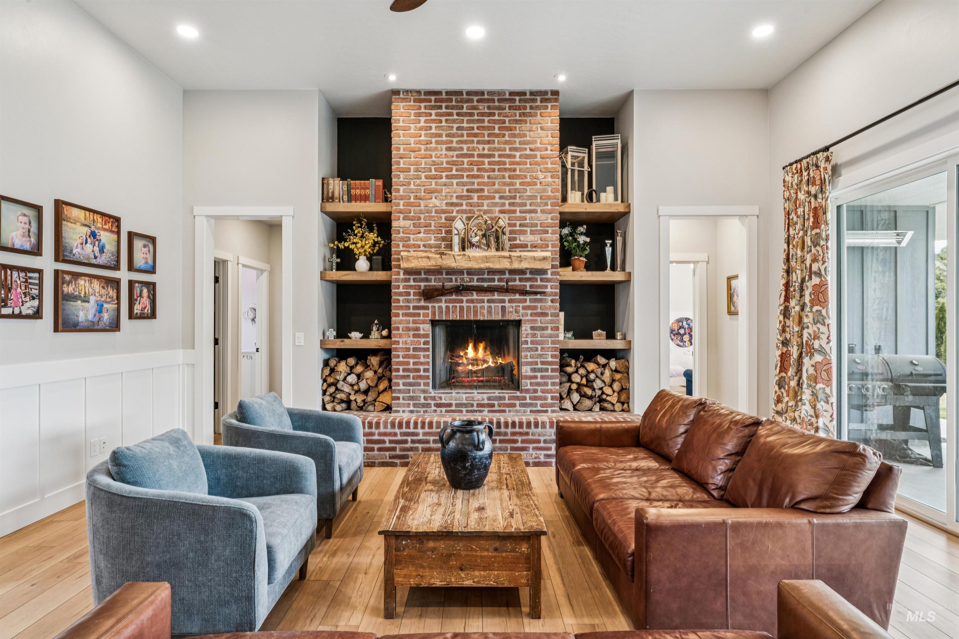 547 Bass Run Lane Marsing, ID 83639 - Photo 15 of 49 Living area featuring hardwood / wood-style floors, a fireplace, recessed lighting, a wainscoted wall, and a decorative wall