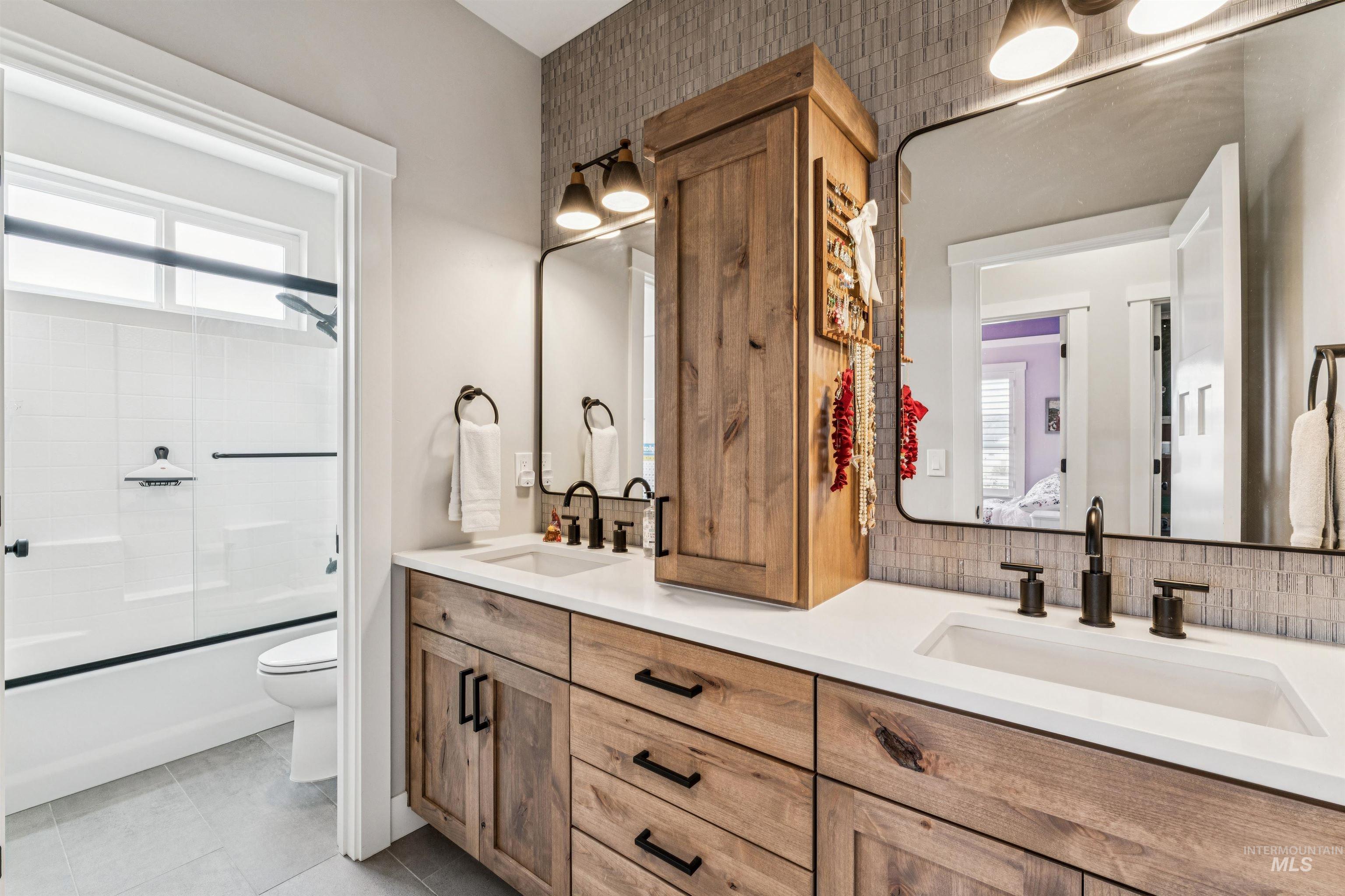 547 Bass Run Lane Marsing, ID 83639 - Photo 23 of 49 Full bath with double vanity, enclosed tub / shower combo, and light tile patterned floors