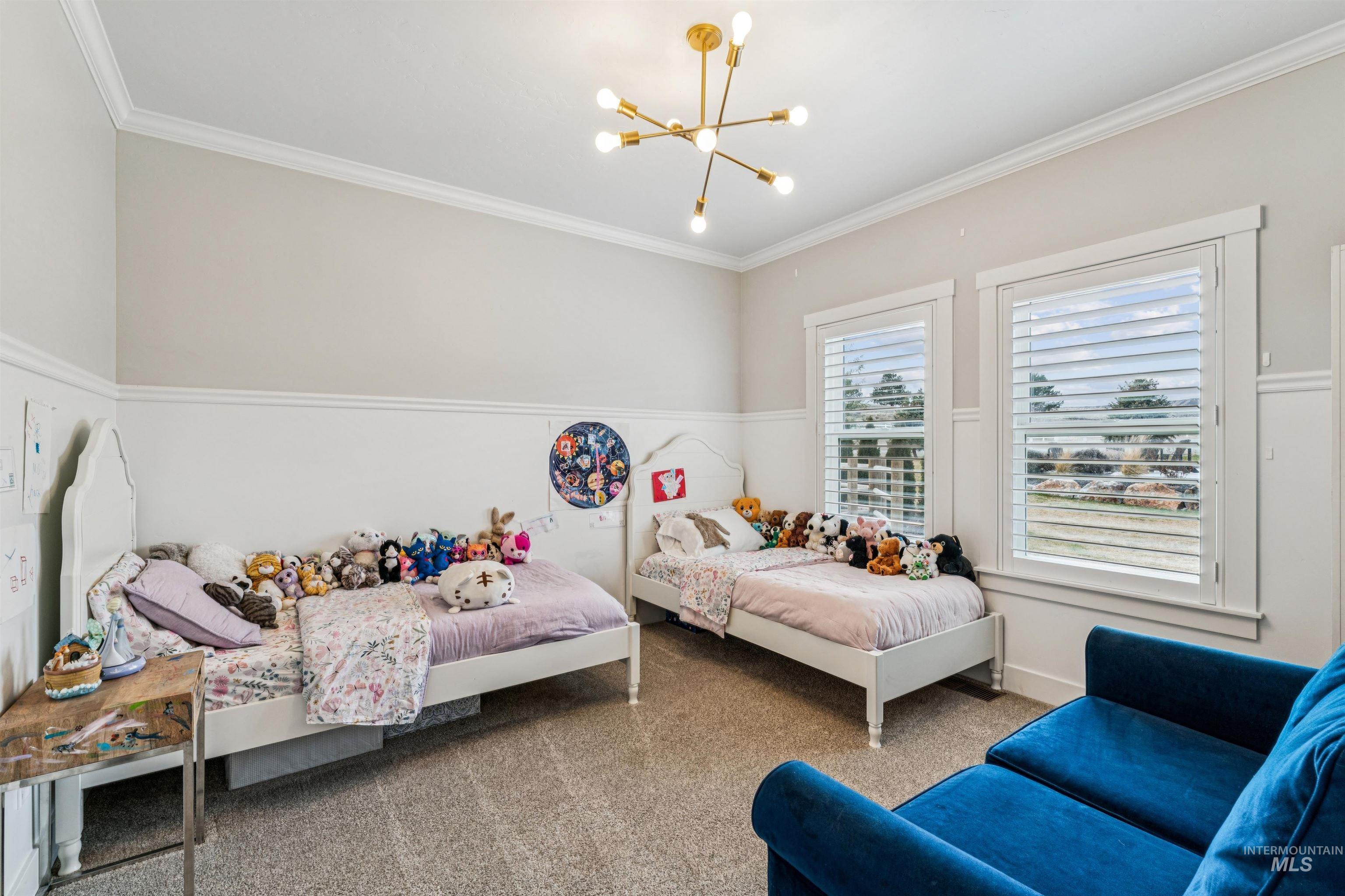 547 Bass Run Lane Marsing, ID 83639 - Photo 25 of 49 Bedroom with crown molding, a chandelier, and carpet floors