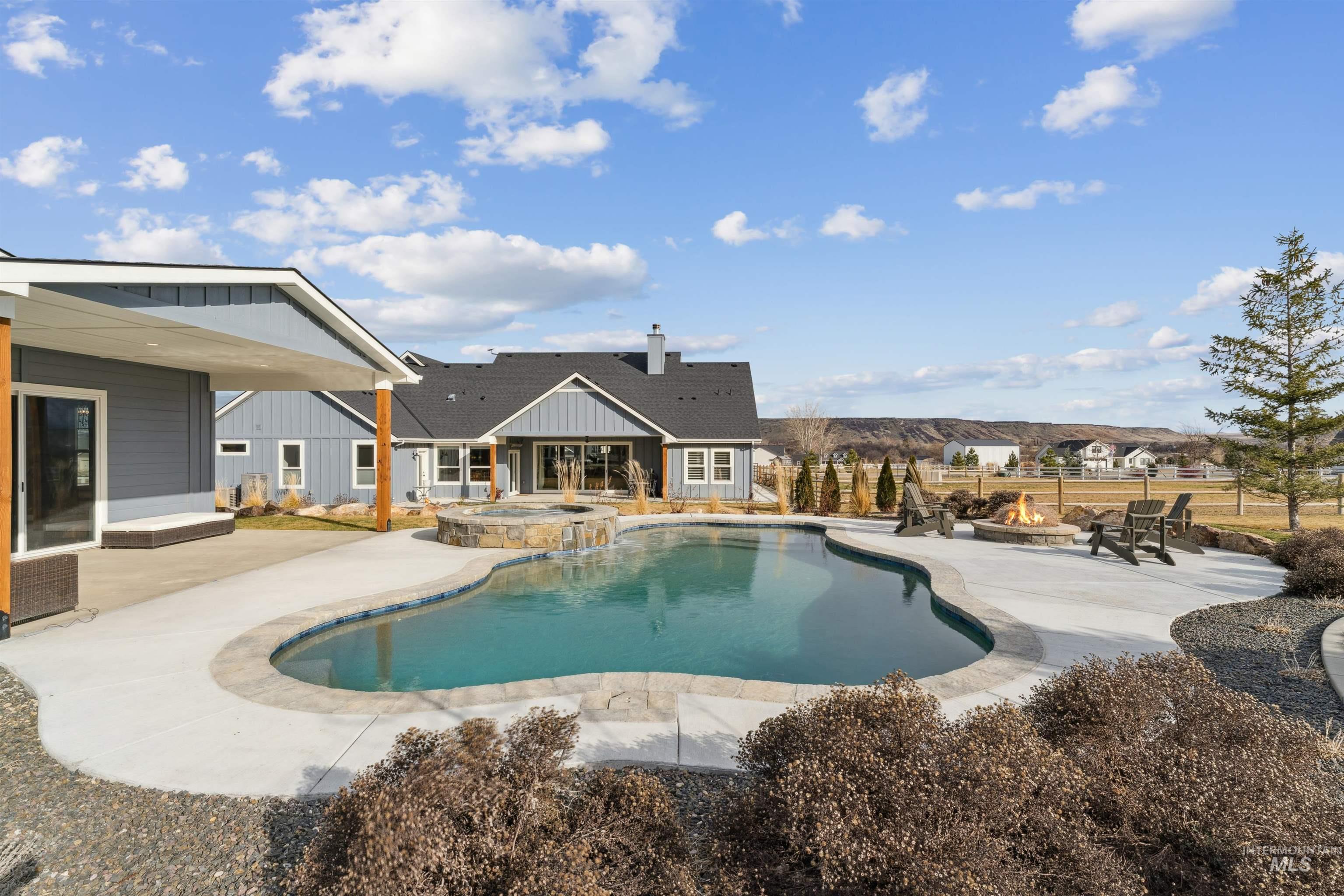 547 Bass Run Lane Marsing, ID 83639 - Photo 29 of 49 Integrated pool / spa featuring a patio and a fire pit