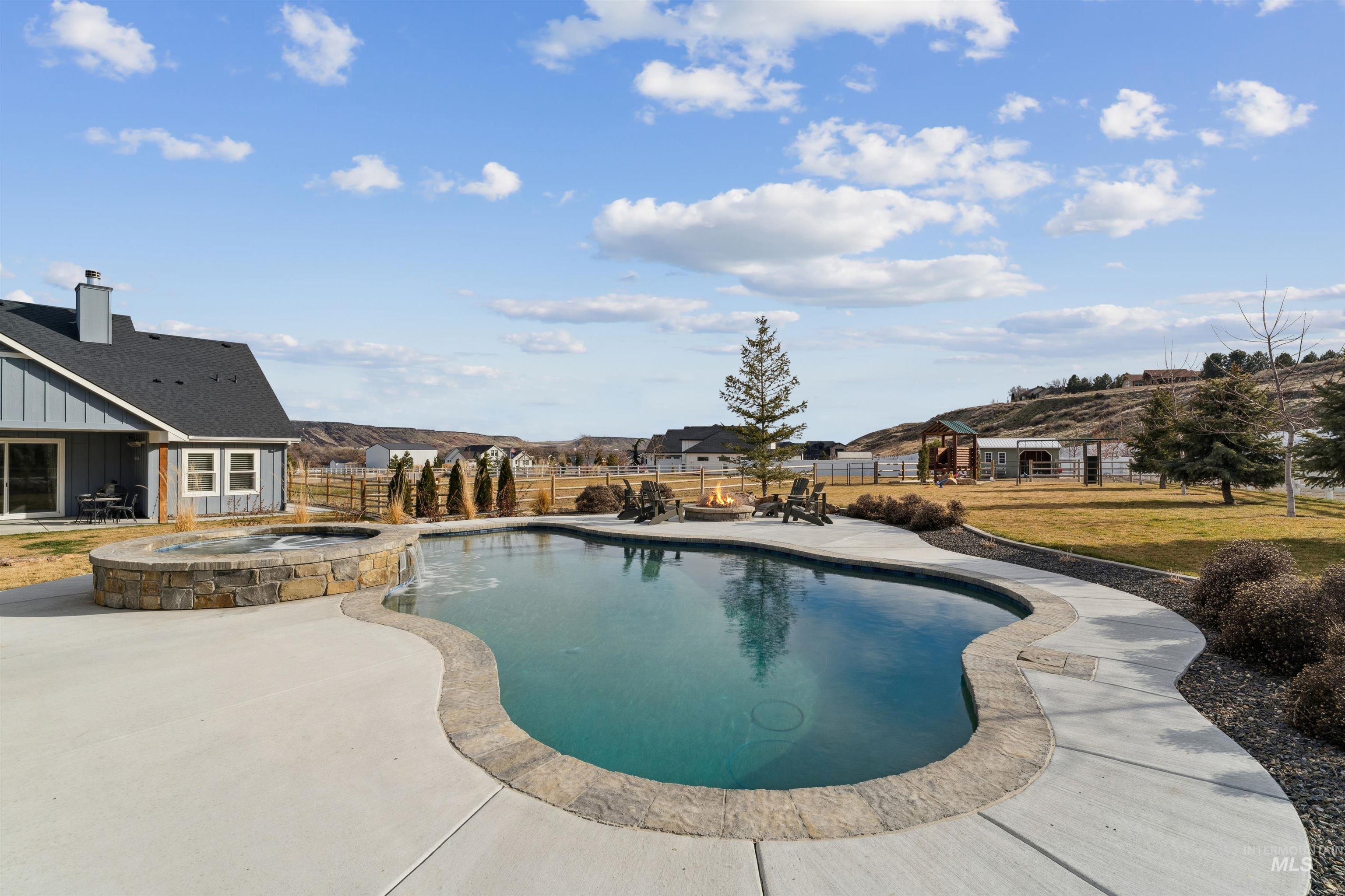 547 Bass Run Lane Marsing, ID 83639 - Photo 31 of 49 Combined pool / hot tub featuring a patio and a fenced backyard