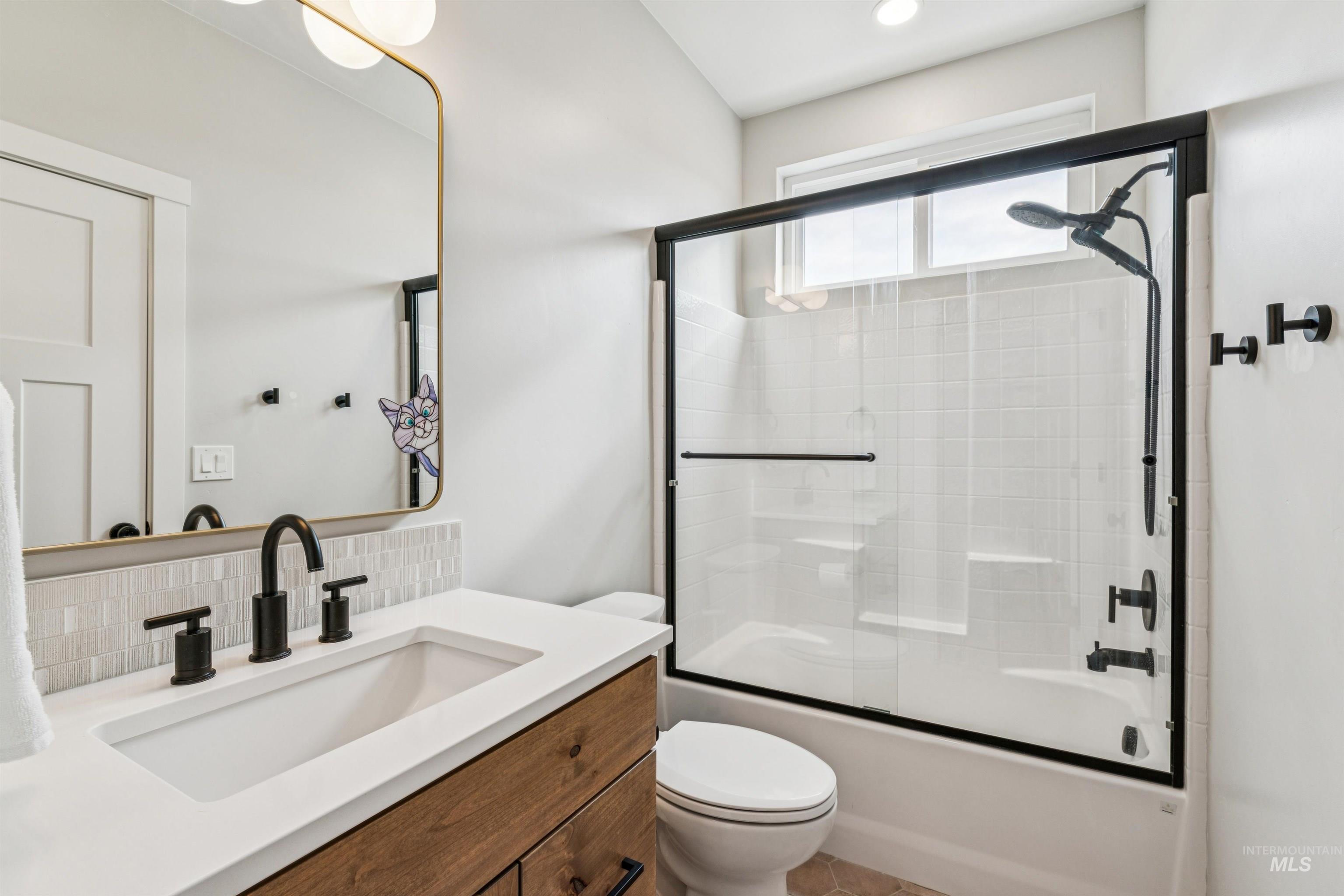 547 Bass Run Lane Marsing, ID 83639 - Photo 48 of 49 Bathroom with bath / shower combo with glass door, vanity, and decorative backsplash