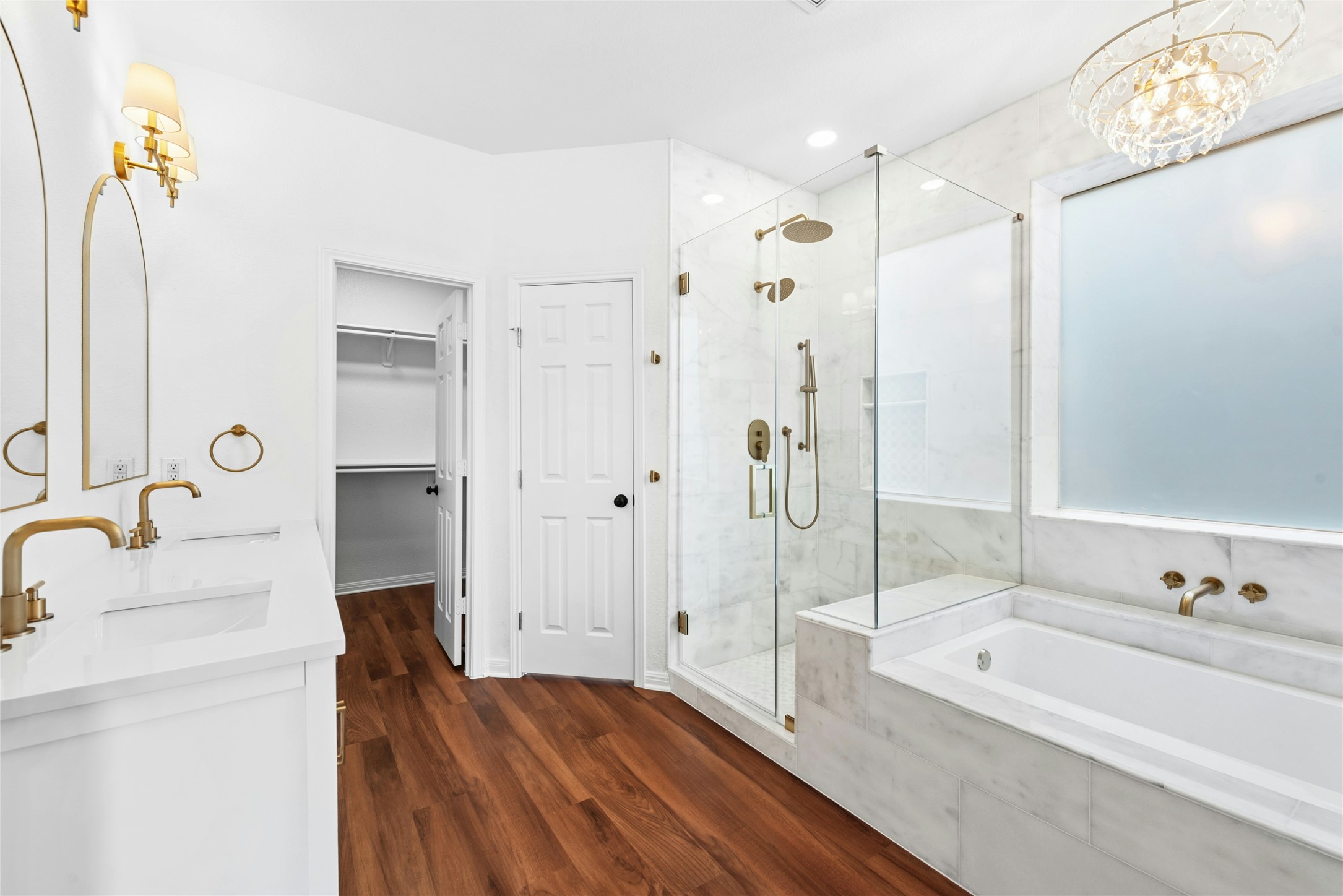 813 Caribou Ridge Trail Pflugerville, TX 78660 - Photo 6 of 39 Luxurious spa-style primary bath with soaking tub, frameless glass walk-in shower with rain head, dual vanity, and marble tile.