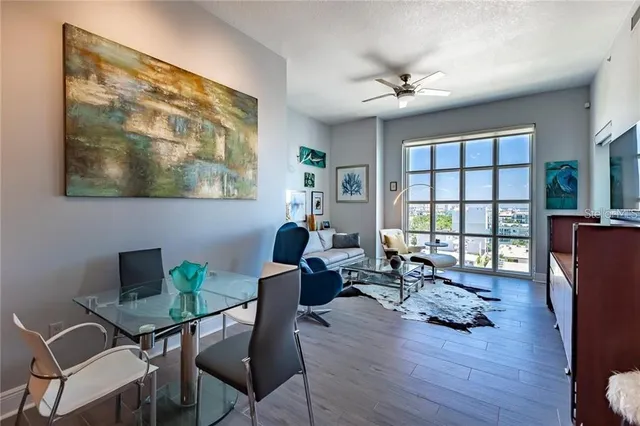 a living room with furniture a rug and a large window