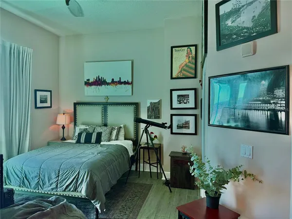 a bedroom with a bed table and window