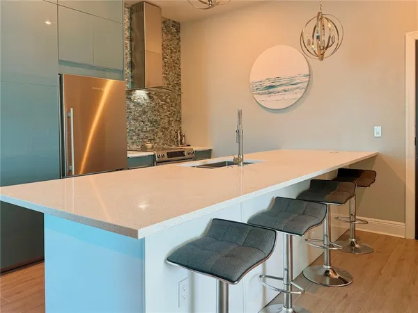 a room with a table chairs and a chandelier