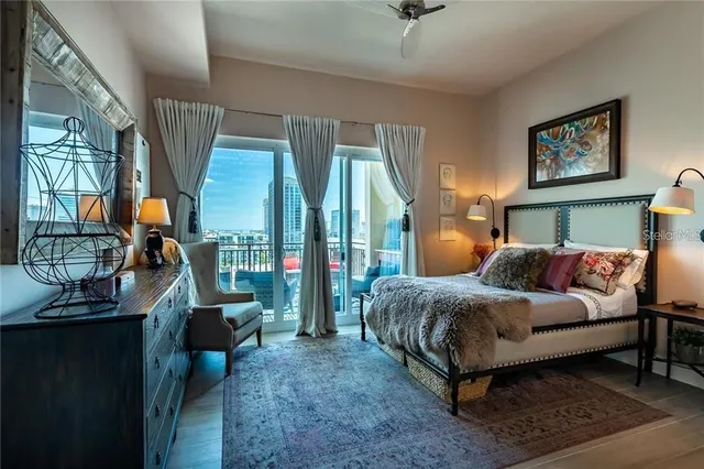 a bedroom with a large bed and a painting on the wall