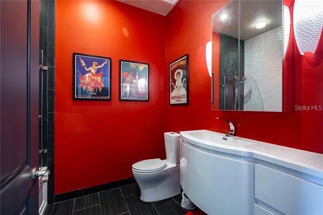 a living room with furniture a potted plant and a fireplace