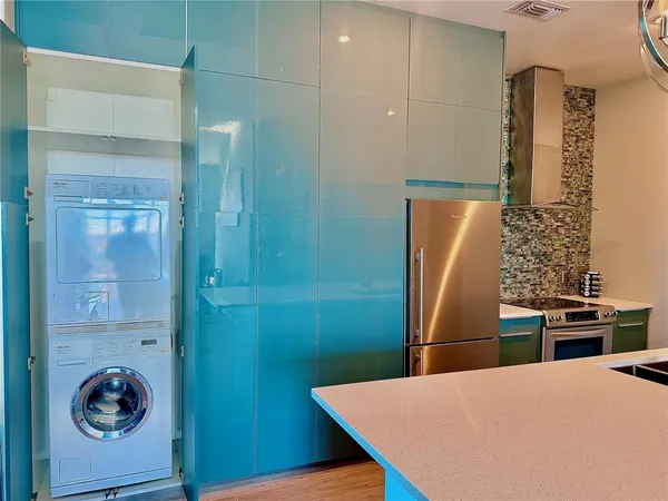 a kitchen with a refrigerator and a stove