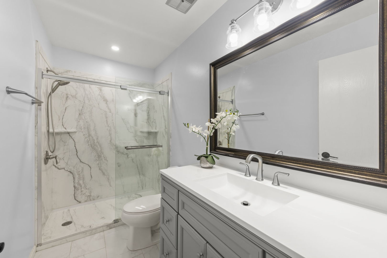 1301 Peshtigo Avenue Naperville, IL 60564 - Photo 18 of 30 a bathroom with a sink toilet and shower