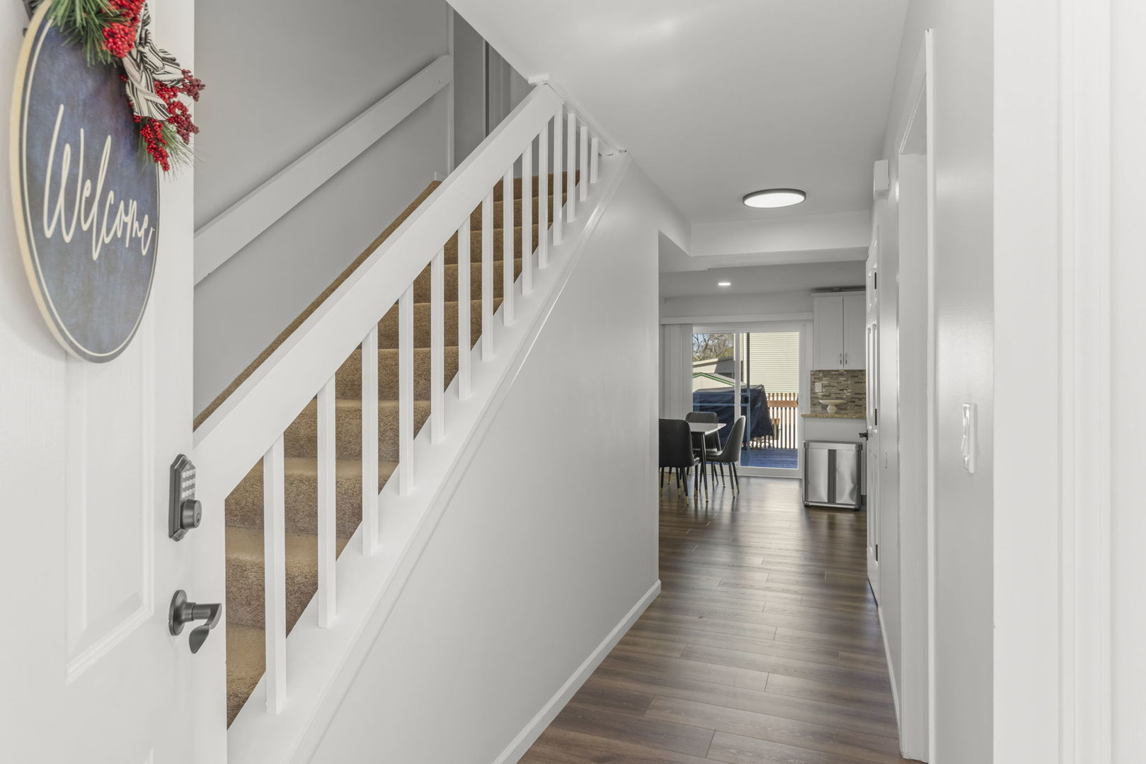 1301 Peshtigo Avenue Naperville, IL 60564 - Photo 2 of 30 a view of a hallway with wooden floor staircase and living room