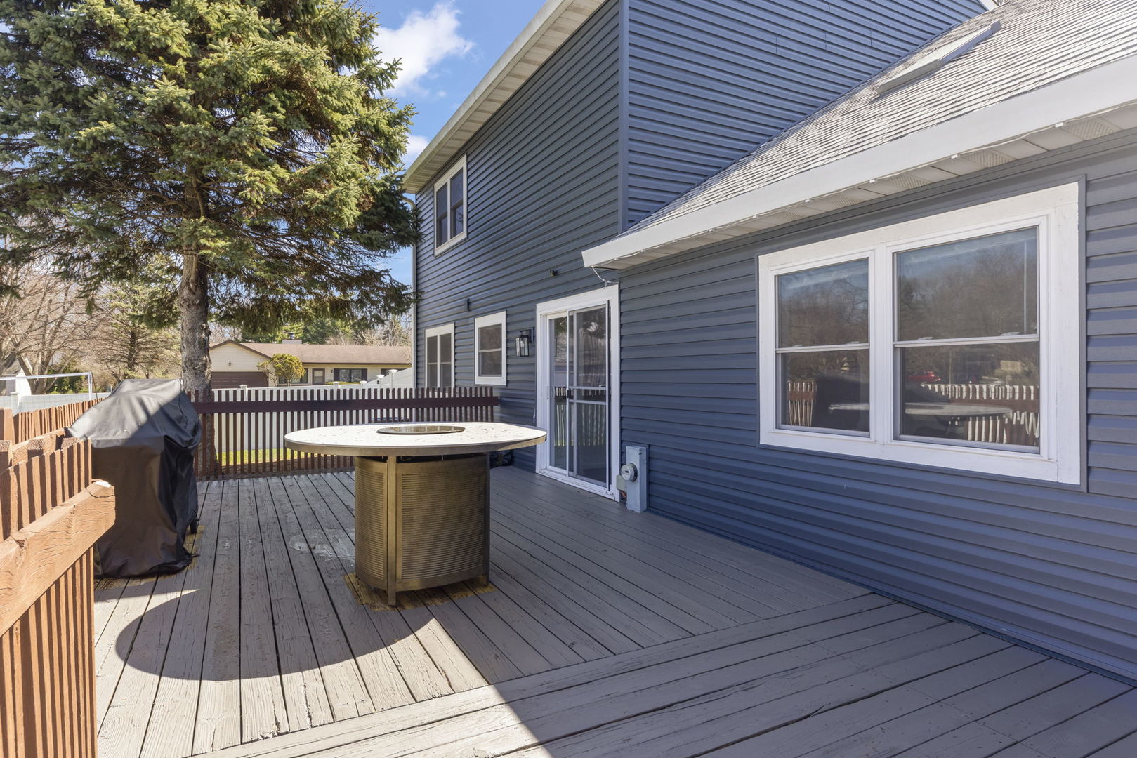 1301 Peshtigo Avenue Naperville, IL 60564 - Photo 24 of 30 a view of a roof deck with wooden floor and fence and a floor to ceiling window