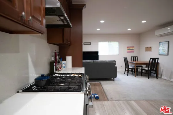 a kitchen with stainless steel appliances granite countertop a stove a sink a microwave and a refrigerator
