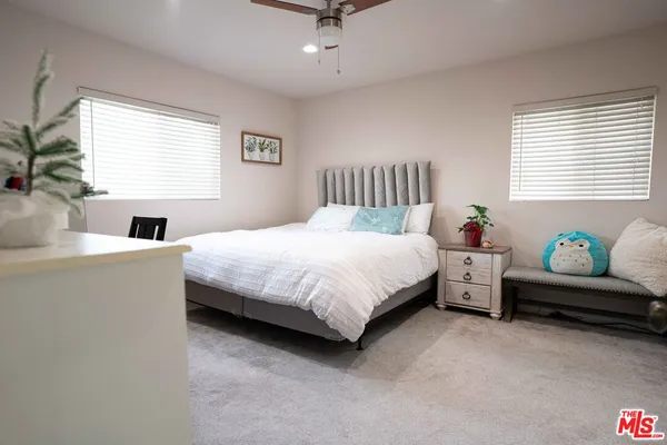 a bedroom with a bed and a couch