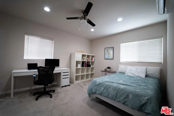 a bedroom with a large bed and furniture