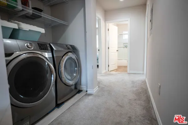 a view of a storage & utility room with a washer dryer